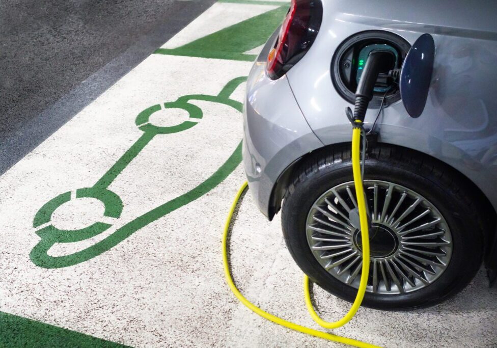 Electric car charging at designated spot.