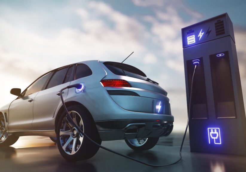 Electric car charging at station.