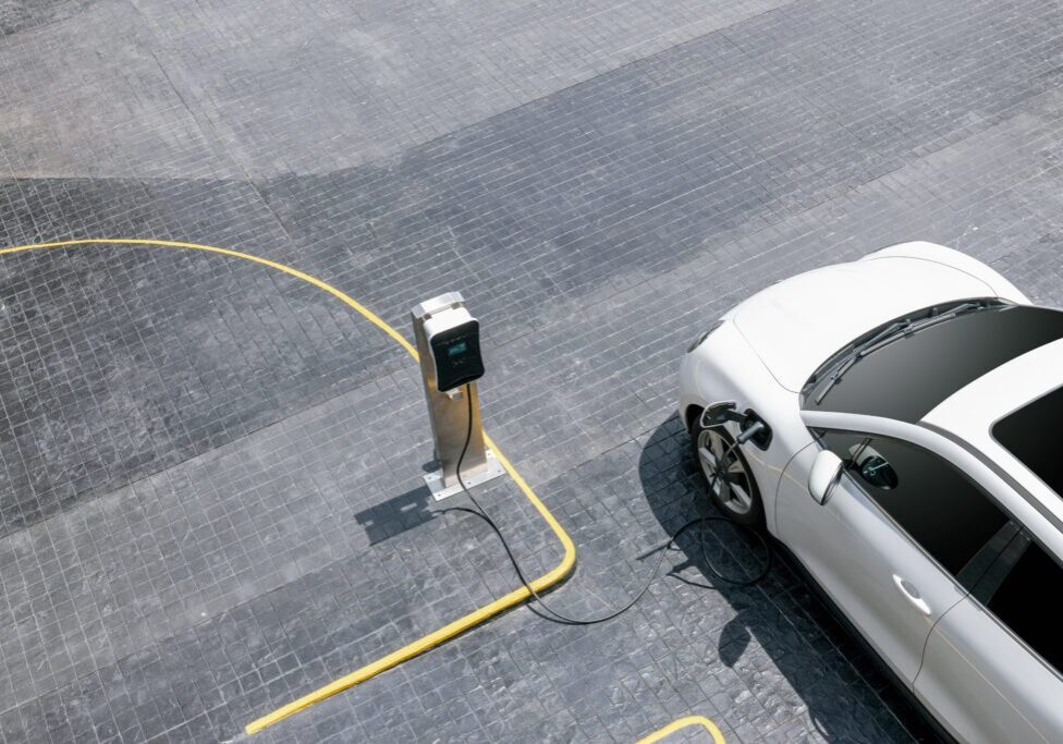 White EV charging at designated station.